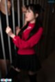 Standing at bars pigtails falling over her red top