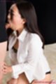 On her knees wearing white shirt sucking cock