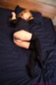 On her side knees raised showing panties