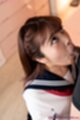 Looking up on her knees sucking cock wearing uniform