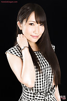 Pushing long hair back wearing gingham dress wrist watch