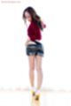 Kisaragi juri raising top over denim shorts looking down at high heels
