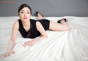 Enami Ryu in sheer black dress on her knees giving handjob and licking cum