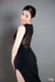 Looking over her shoulder in black dress