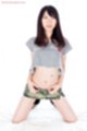 On her knees wearing short skirt thighs parted