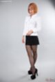 Office lady in glasses legs crossed wearing pantyhose high heels