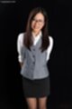 Office lady standing hands behind her back wearing glasses