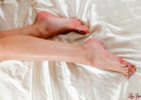 Long haired beauty Kamimoto Rio on her back giving footjob and cum on feet