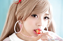 Lips around cherry wearing hooped earrings