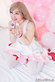 Kasugano yui kneeling holding lollipop wearing stockings in high heels