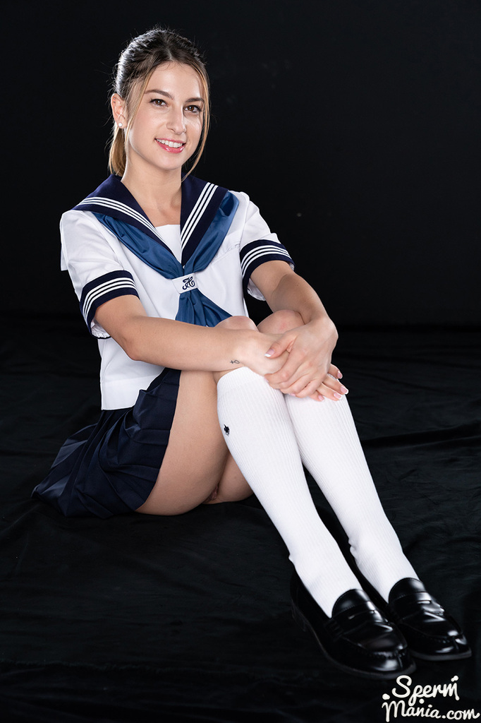Seated with knees drawn up wearing kogal uniform