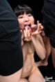 On her knees nude licking two cocks