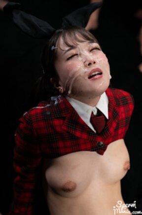 Kurumi Ria kneeling surrounded by men receiving bukkake facial cumshots