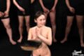 On her knees nude hands raised