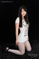 Kneeling in white tshirt long hair in pantyhose wearing high heels